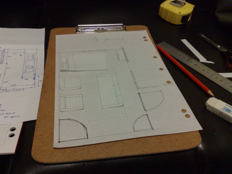 Desperately trying to get everything to fit using a floor plan on graph paper and little furniture cutouts.